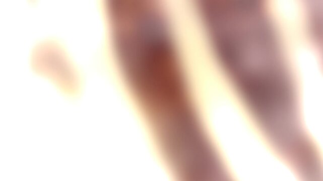 Blurry Warm-Toned Light Flares on Overexposed Bright White Abstract Background