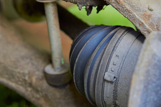 Car CV joint boot with metal clamp close up, Replacement and maintenance of the car CV joint protective boot