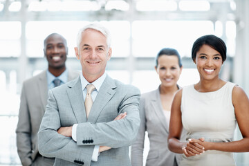 Obraz premium Team, portrait and business people with arms crossed in office, pride or happy with financial growth. Corporate company, leader and solidarity with colleagues, smile and collaboration for project