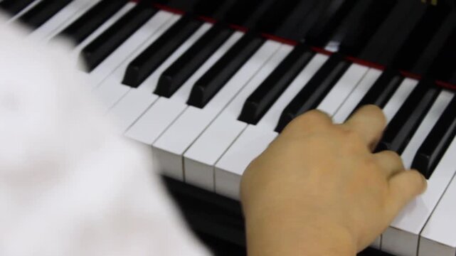 The hands of an unrecognizable person are creating classical music on the keyboard of an antique piano as a method of distraction and therapy. Concept of handmade and artistic
