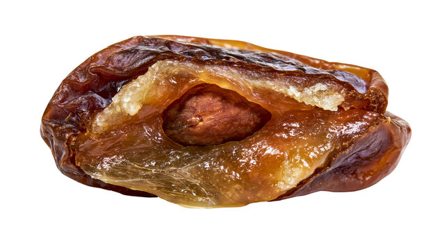 Dried Medjool date with visible pit and wrinkled skin, isolated on transparent background