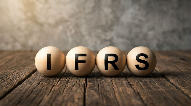 IFRS text written on wooden balls on rustic table finance concept