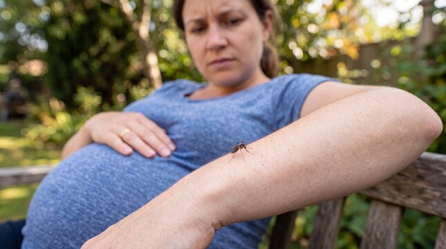 Expectant Mother Observing Insect on Arm While Sitting in Garden During Daytime in Natural Outdoor Setting