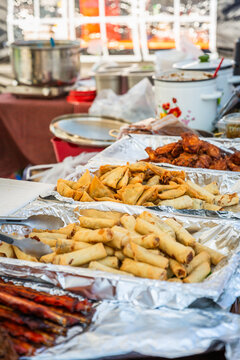 Delicious fried spring rolls and samosas served at an outdoor food stall