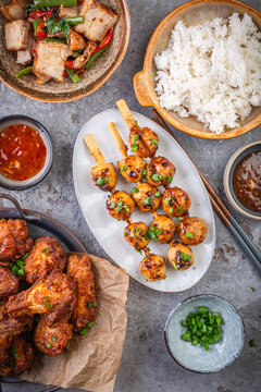 Deliciously grilled meat skewers served with tangy sauce and fresh green onions