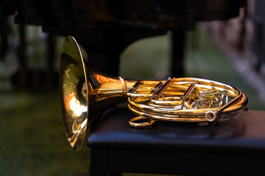 French horn resting on a bench, ready for a street concert performance