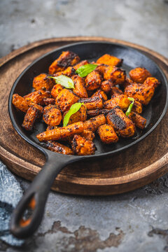 Delicious roasted carrots seasoned with herbs served in a cast iron skillet