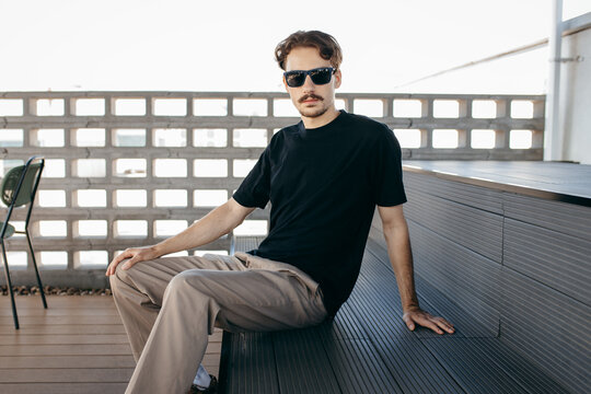 Man wearing black blank t-shirt with space for your logo or design. Mock up	
