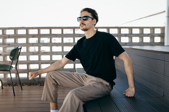 Man wearing black blank t-shirt with space for your logo or design. Mock up	
