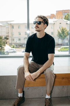 Man wearing black blank t-shirt with space for your logo or design. Mock up	
