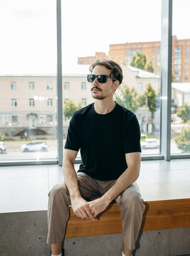 Man wearing black blank t-shirt with space for your logo or design. Mock up	
