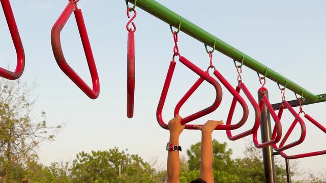 Kids Outdoor Fitness And Play On Colorful Monkey Bars At Sunset