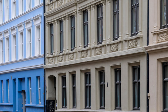 In Gr&uuml;nerl&oslash;kka, blue and cream buildings set a measured rhythm, while ornament frames windows across facades and reveals detail in the architecture of Oslo, Norway.