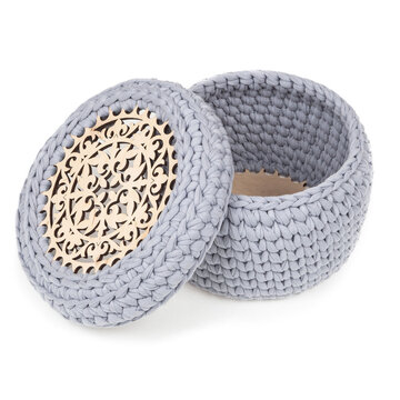 Professional studio product photography featuring an open knitted textile organizer. Perfect layout template of a handmade cotton yarn basket for luxury gift shop retail catalog.
