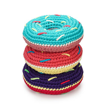Professional studio product shot of three round textile donut plush toys. Perfect presentation template of handmade cotton yarn storage pillows for online retail store catalog.