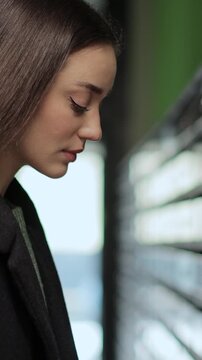 Vertical video Young woman opening and checking mailbox in apartment building. Mail shipping concept.