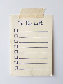 Handwritten to-do checklist on paper with masking tape. Minimalist daily task planner for productivity and organization.