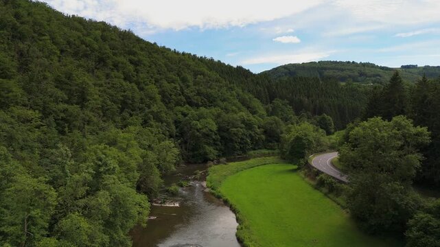 Motorcycle Cornering on Scenic Valley Road in Luxembourg