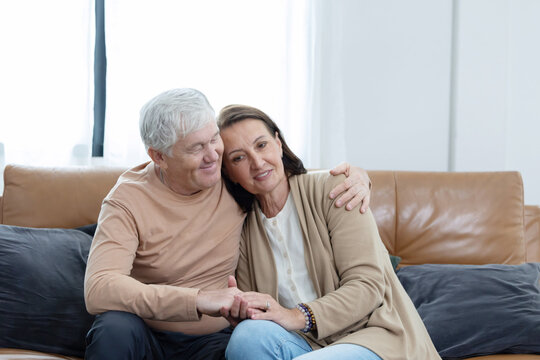 An elderly couple spends time together in living room