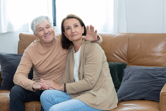 An elderly couple spends time together in living room