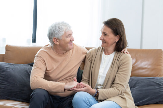 An elderly couple spends time together in living room