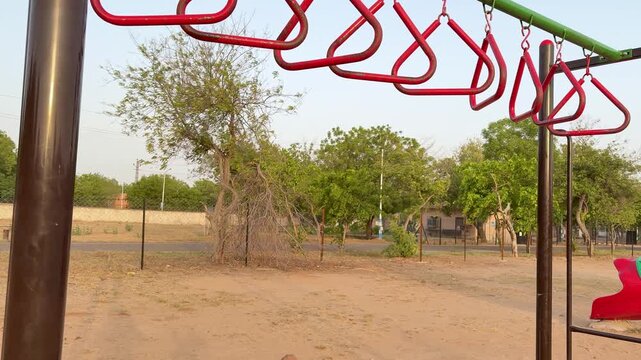 Young Child Developing Strength And Coordination On Playground Monkey Bars Outdoors