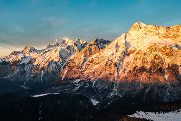 Fototapeta premium Aerial view of sunrise golden light on Yulong Snow Mountain, Lijiang Yunnan China