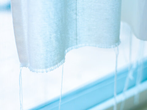 Soft Blue White Sheer Fabric Curtain Close-Up with Natural Light Abstract Background