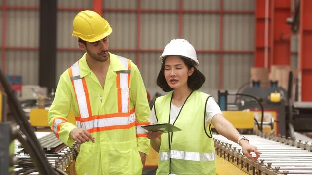 Supervisors inspecting production workflow and monitoring factory operations with digital technology. Manufacturing management, industrial innovation and operational efficiency.