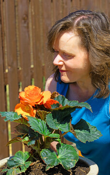 Lady with an orange begonia.