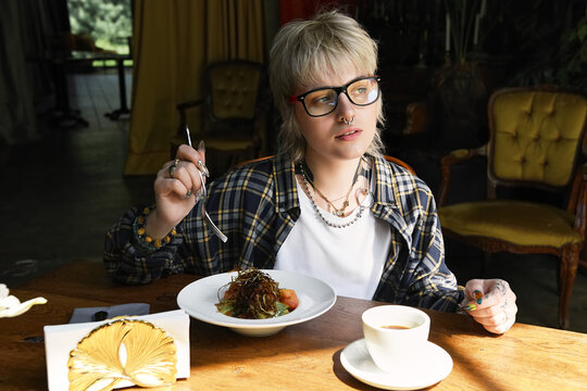 Cozy moments in a cafe with a stylish non binary friend enjoying a delicious meal