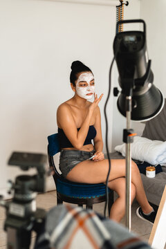 Woman With Facial Mask Sitting in Chair During Skincare Session