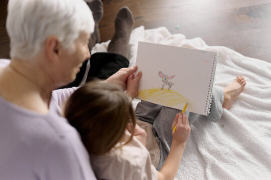 Grandmother and child drawing together