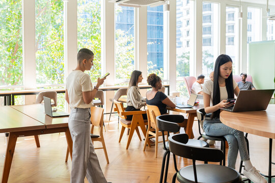 Work and Study Taking Place in a Bright Modern Coworking Space