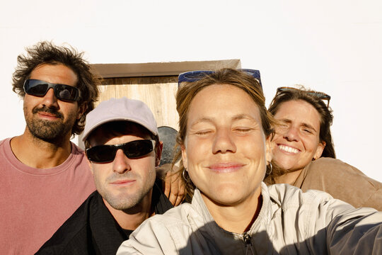 UGC selfie of four friends smiling together on roadtrip stop