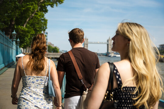 Group of friends exploring London's riverside together