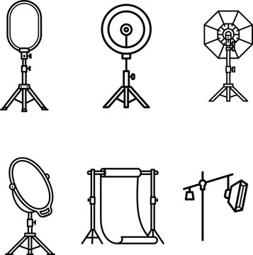 Various photography studio equipment on stands and tripods for lighting and backdrop setup