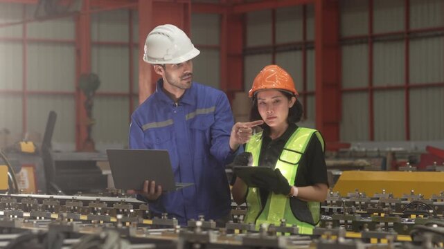 Supervisors inspecting production workflow and monitoring factory operations with digital technology. Manufacturing management, industrial innovation and operational efficiency.
