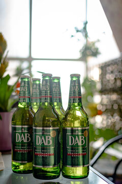 Athens,Greece-July 12 2026. Bottles of the DAB German beer on a glass table. Vertical photo,nice soft background.