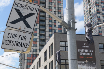 Obraz premium traffic signs and banner of The Diamond, an apartment building complex located at 950 Lansdowne Av, Toronto