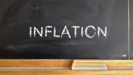 blackboard with chalk, the word inflation written with white chalk © es
