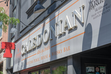 Obraz premium exterior building facade and sign of The Caledonian, a pub, located at 856 College St, Toronto