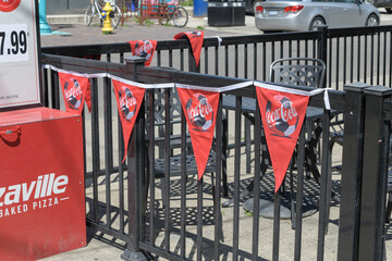 Obraz premium Coca-Cola bunting on a railing at Pizzaville located here at 796 College St, Toronto