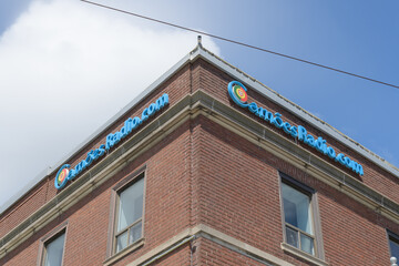 Obraz premium building sign on the exterior of Camões TV, a television studio, a Portuguese-language media org located at 722 College St, Toronto