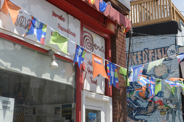 Obraz premium FIFA World Cup bunting with flags outside Latin Taste, a Peruvian restaurant, located at 200 Baldwin St, Kensington Market, Toronto