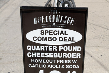 Obraz premium sidewalk sign of The Burgernator, a hamburger restaurant, located at 269 Augusta Av, Kensington Market, Toronto