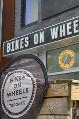 Obraz premium exterior building facade and signage of Bikes on Wheels, bicycle shop, located at 299 Augusta Av, Kensington Market, Toronto