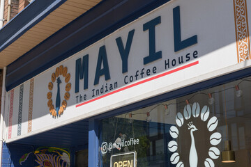 Obraz premium vinyl window sign and text at Mayil Coffee, a coffee shop, located at 870 College St, Toronto