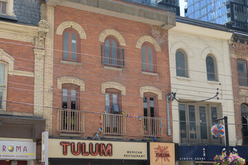 Obraz premium historic building facade and sign of Tulum Mexican Restaurant located at 291 King St W, Toronto