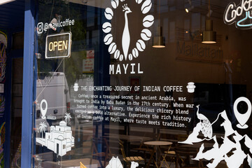 Obraz premium vinyl window sign and text at Mayil Coffee, a coffee shop, located at 870 College St, Toronto